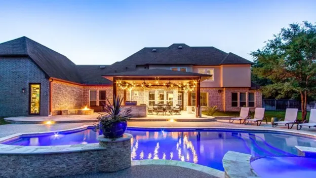 Custom pool remodel Houston backyard with modern deck and outdoor seating