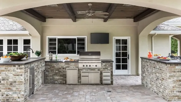 Outdoor kitchen design in Houston TX with grill and seating area
