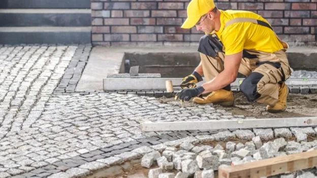 Paver walkway installation in backyard with modern landscape design